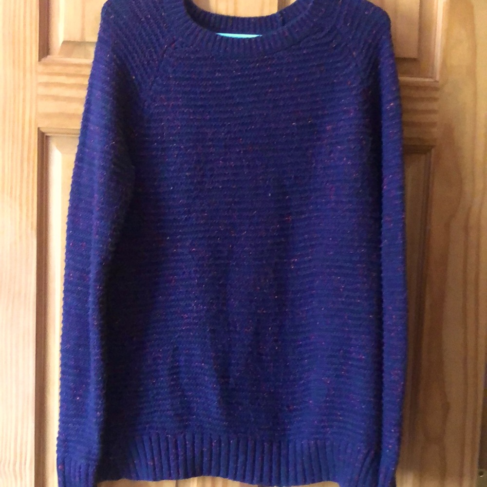Warm blue sweater with red accents